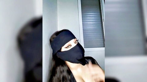 Seductive Arab MILF in black niqab teases with sultry eyes on webcam