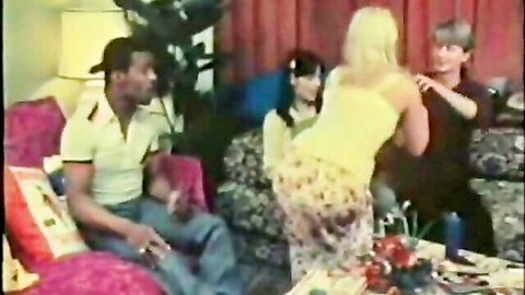 Vintage busty blonde in yellow top bending over for black man in classic foursome XXX