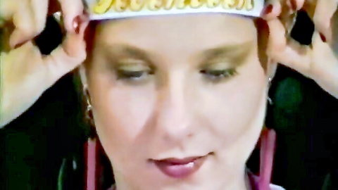 Vintage Danish teen with sensual gaze, gold crown headband, red lips