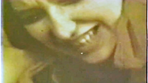 Vintage blonde smiling teasingly in retro porn close-up