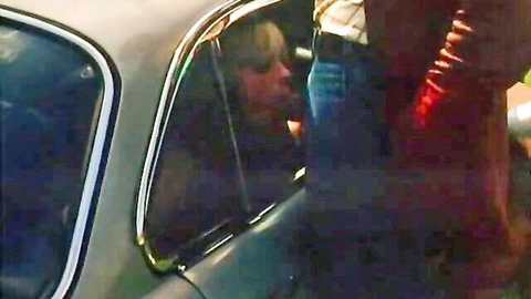 Blonde woman kisses man through car window in German retro car sex roleplay