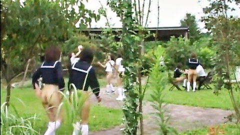 Japanese schoolgirls in uniforms flashing bare asses and pussies while walking in outdoor garden