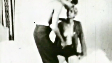 Vintage black and white image of two suited men in intimate embrace