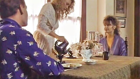 Blonde pouring tea in vintage femdom scene from Chameleons classic