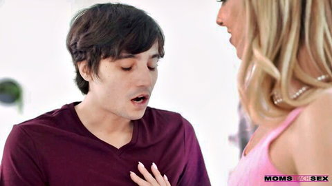 Millie Morgan as busty blonde stepmom in pink top facing surprised young stepson