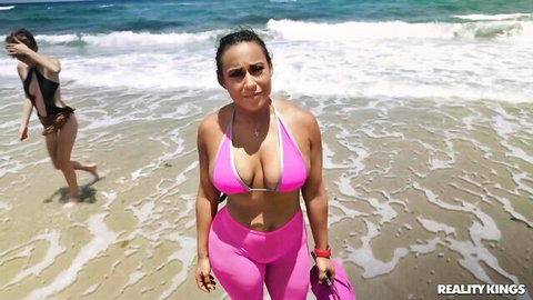 Alicia Williams in tight pink bikini on sunny beach, busty Latina curves