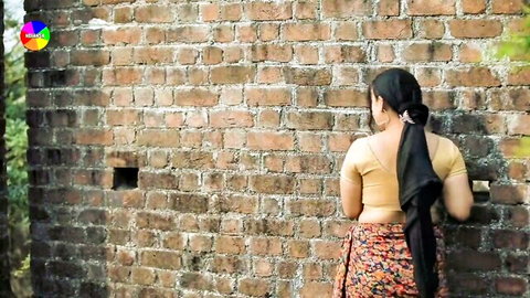 Sexy Indian woman with big juicy ass in saree bending teasingly against brick wall