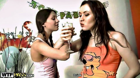 Two sexy brunettes in tight tank tops toasting champagne glasses at wild birthday party