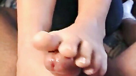 Pale bare foot toes gripping and stroking erect cock in close-up footjob action