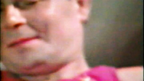 Blurry close-up of skinny woman's face in pink top from Videorama kinky classic