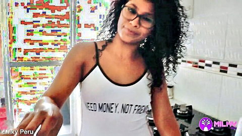 Curly-haired ebony teen fitness influencer in white tank top posing seductively