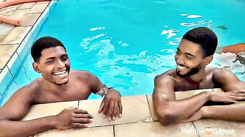 Two shirtless black men smiling by the pool in bisexual couple swap video with Rebeca Villar