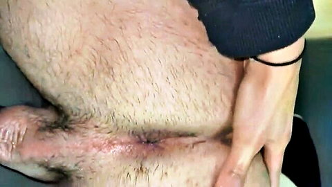POV closeup of woman's hand spreading hairy man's balls exposing red perineum and anus