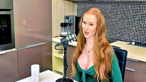 Redhead babe with deep medium tits cleavage speaking sensually into microphone