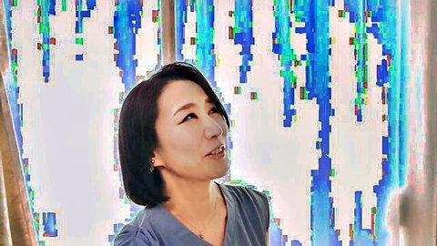 Reiko Seo, mature Japanese woman in light blue top, thoughtful gaze