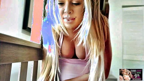 Blonde with massive tits spilling from tight pink top exhaling smoke seductively