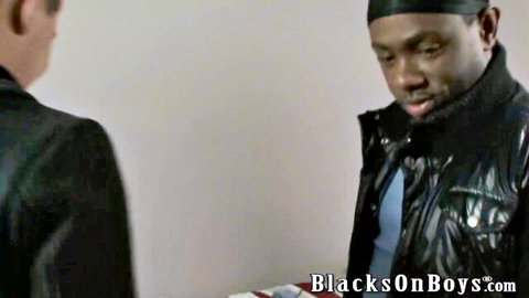 Two Black men in leather jackets, intense stare, BlacksOnBoys interracial threesome preview