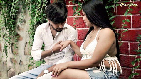 Intimate Indian couple in revealing crochet top and shorts, close embrace outdoors