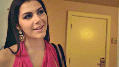 Valentina Nappi in sexy pink dress, smiling seductively near door