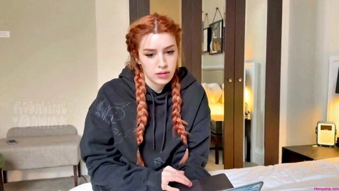 Rosaline Dawn with red braids in black hoodie, seductive gaze
