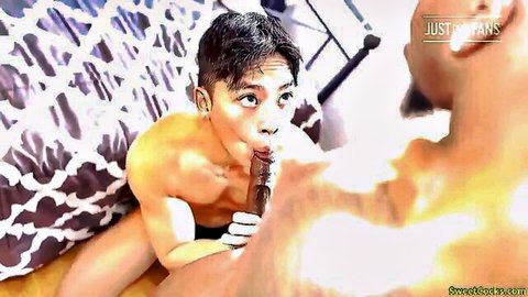 Young Asian guy kneels sucking massive black cock as ebony stud grips his head in gay blowjob