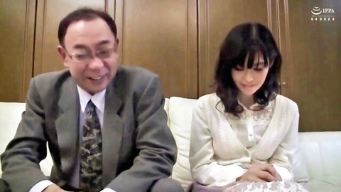 Japanese MILF in white dress sitting with suited older man, JAV setup