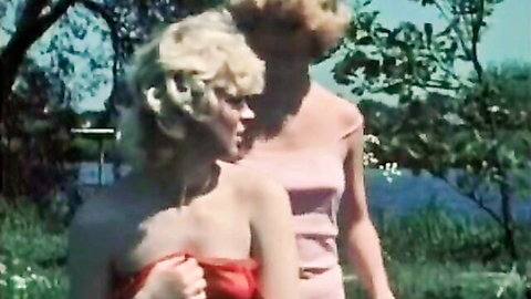Blonde short-haired teen in red dress outdoors with brunette in pink top, classic Color Climax scene