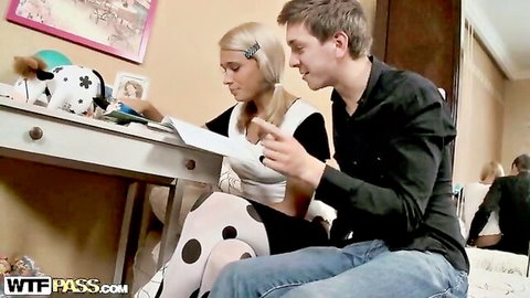 Blonde pigtail teen in polka dot stockings shows deep tits cleavage sitting with guy reading paper in bedroom