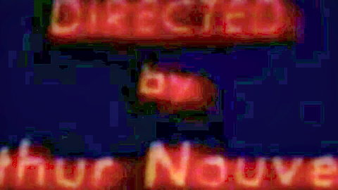 Retro neon sign reading 'Directeur Nouveau' glowing red on dark background