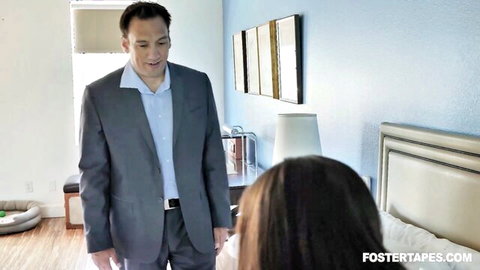 Alex Coal poses naughtily with foster dad in suit on bed