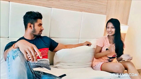 Desi Indian couple smiling flirtatiously on hotel bed before intense fuck