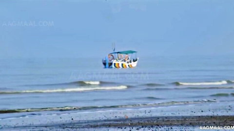 Colorful boat with people on serene beach sea under blue sky