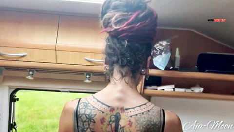 Tattooed babe in sheer black top shows off intricate back tattoos in camper van POV