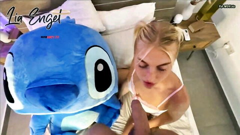 Blonde Lia Engel in lingerie giving blowjob beside Stitch plush toy