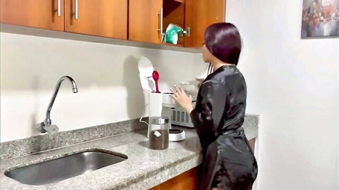 Sexy brunette in shiny black satin robe at kitchen sink showing juicy ass cheeks