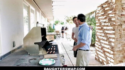 Two fair-skinned DILFs chatting by sizzling sausages on outdoor BBQ grill with bikini babes in background