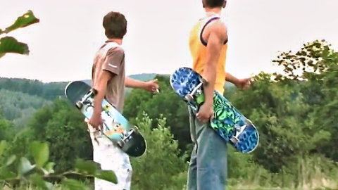 Two athletic skater guys outdoors in casual clothes, amateur gay hookup vibe