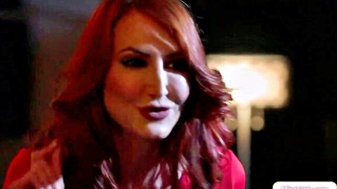 Seductive redhead mature with long wavy hair and glossy pouty lips closeup