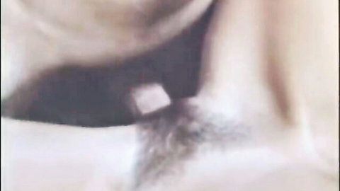 Blurry close-up of woman's hairy pussy area censored by white square