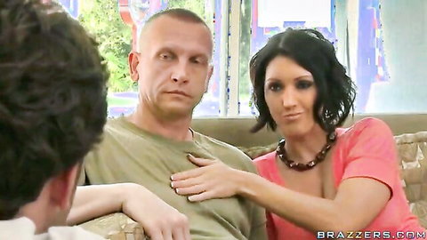 Stepmom in pink top touches stepson's chest as friend watches, teasing punishment scene