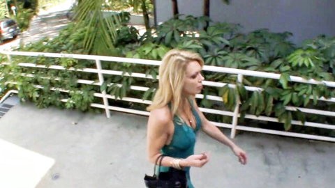 Blonde cougar Alexa Styles in sexy teal dress, walking outdoors teasingly