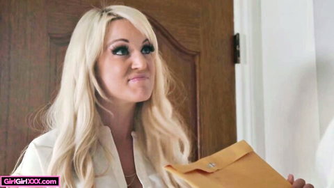 Blonde babe in open white blouse pouting seductively while holding yellow envelope at door