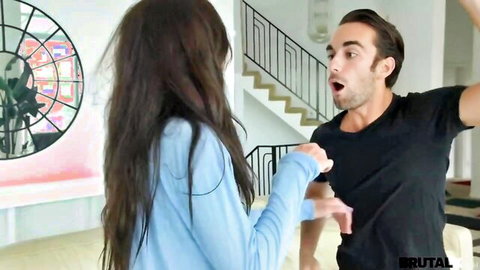Brunette in light blue top roughly grabbed on arm by shocked guy in black t-shirt