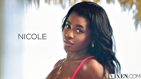 Seductive ebony beauty Nicole in tight pink top showing deep cleavage teasing viewer