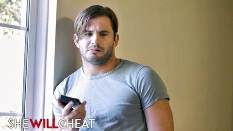 Brunette man in gray t-shirt holds phone by window with 'I WILL CHEAT' text overlay