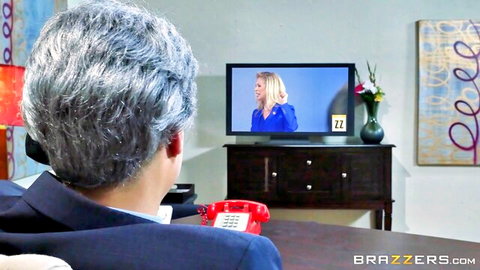 Eva Karera in blue dress on TV, watched by suited man in steamy fantasy