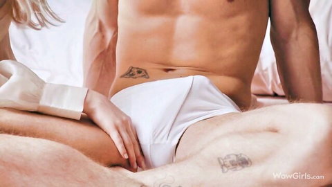 Emma White touches muscular man's bulge in white briefs on bed
