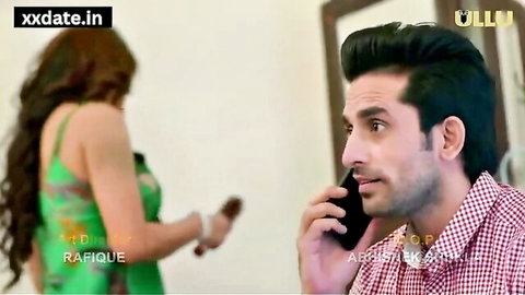 Indian MILF in green dress turns away as man talks on phone in steamy scene