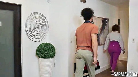 Sara Jay in gray sweater and purple leggings as coach, approached by curly-haired black player