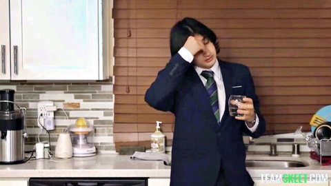 Anna Starr in sexy suit and tie, facepalming seductively in kitchen